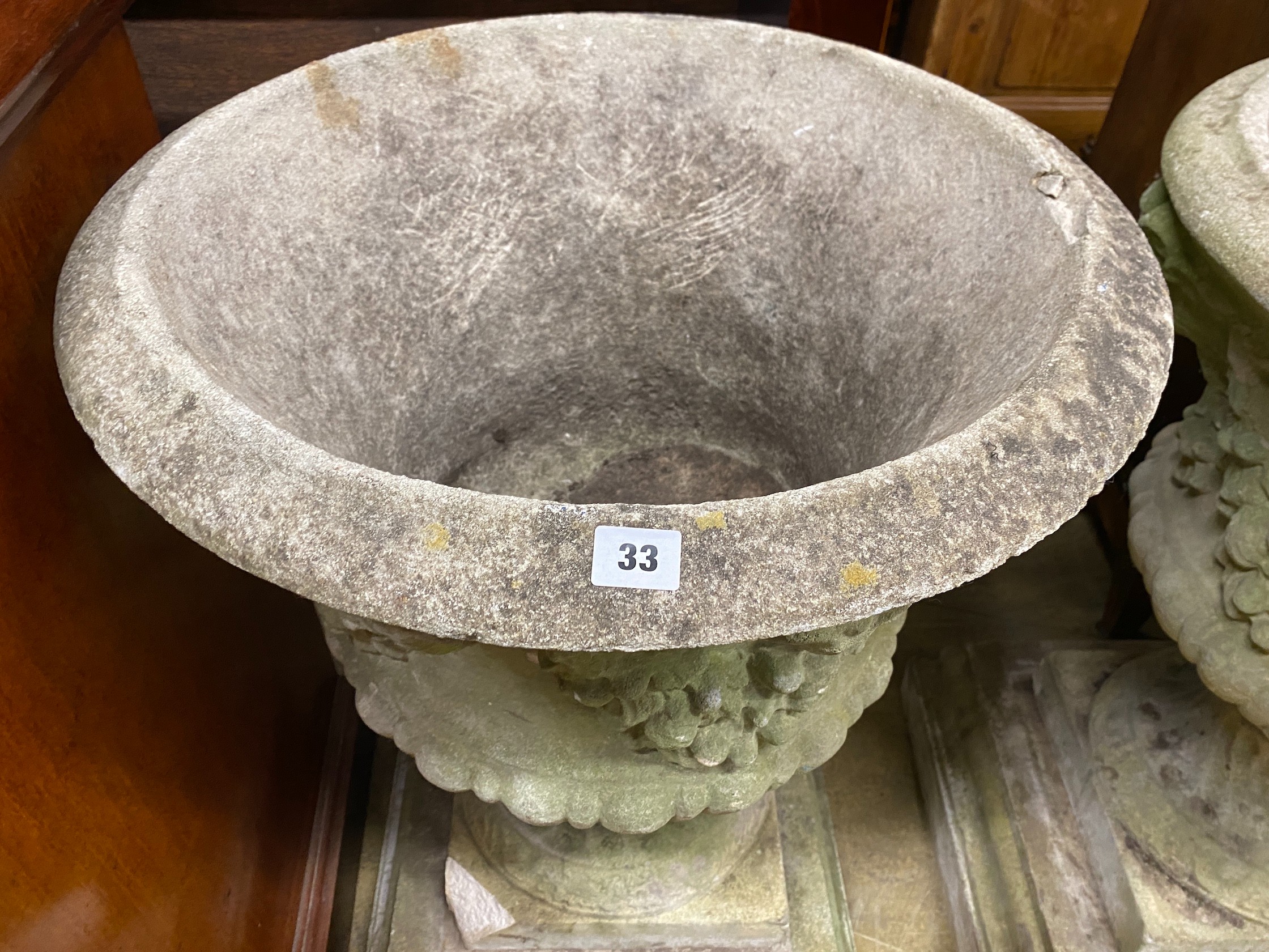 A pair of circular reconstituted campana garden urns with floral swagged bodies, diameter 59cm, height 86cm